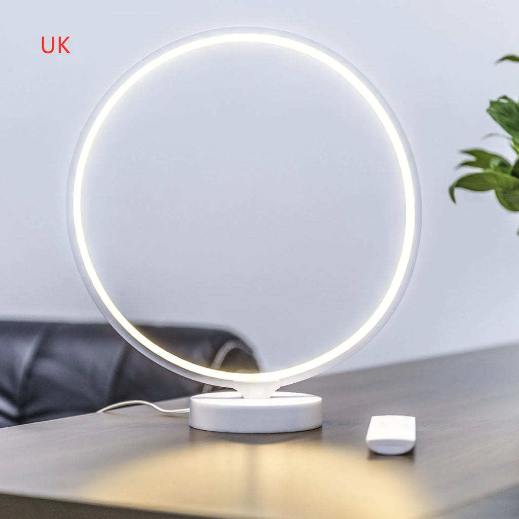White Full Moon mood lamp on a table with remote control, showing soft ambient glow.