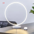 White Full Moon mood lamp on a table with remote control, showing soft ambient glow.