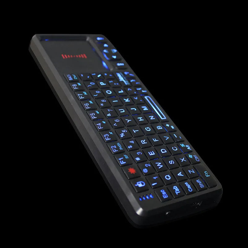 Black wireless mini keyboard with touch screen and optical mouse on desk