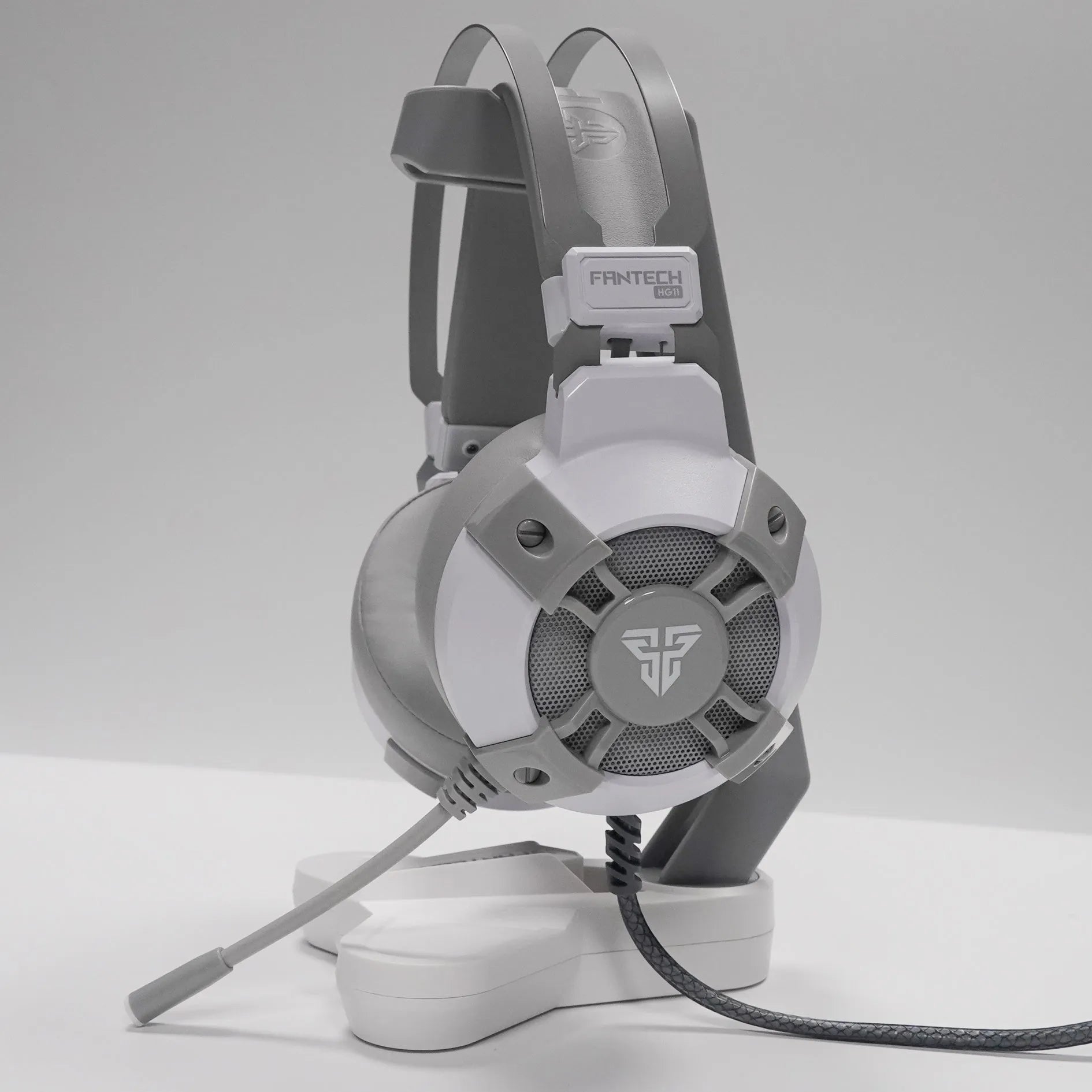 Black FANTECH HG11 over-ear gaming headset with RGB lighting on the earcups and a USB cable.