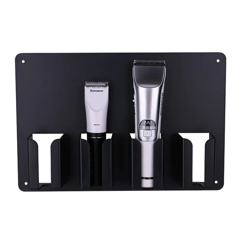 Black plastic wall-mounted storage rack holding four hair clippers
