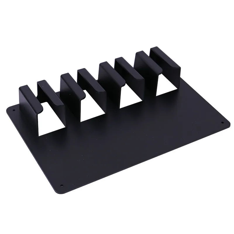 Black plastic wall-mounted storage rack holding four hair clippers
