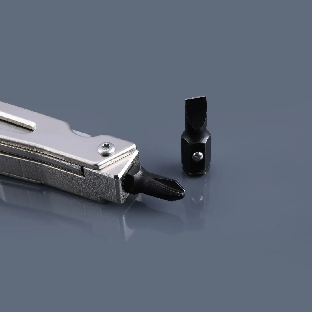 White multi-function tool with stainless steel knife blade, adjustable wrench head, and needle-nose pliers.