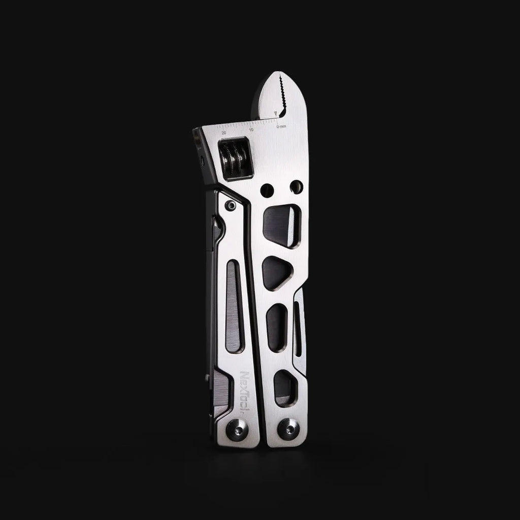 White multi-function tool with stainless steel knife blade, adjustable wrench head, and needle-nose pliers.