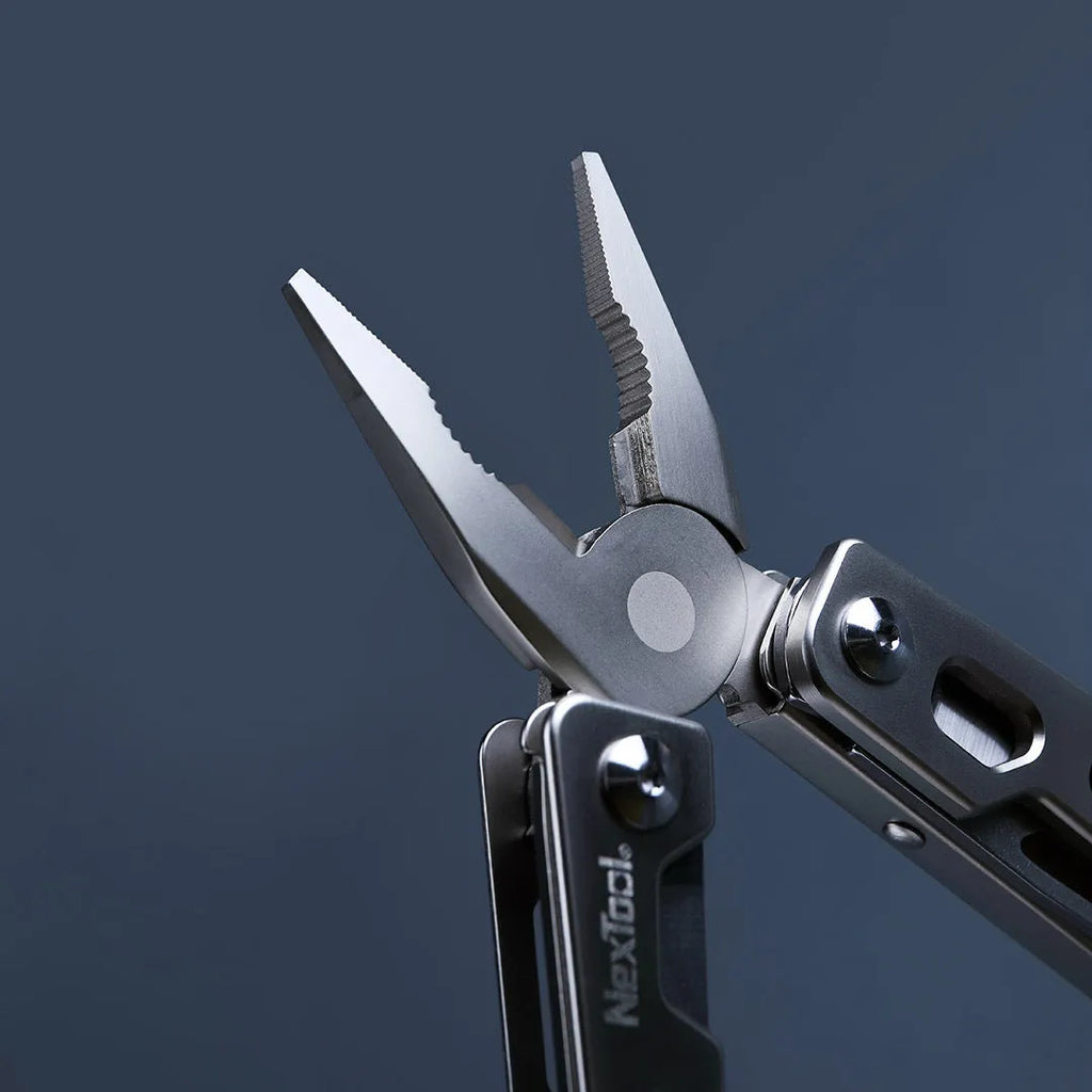 White multi-function tool with stainless steel knife blade, adjustable wrench head, and needle-nose pliers.
