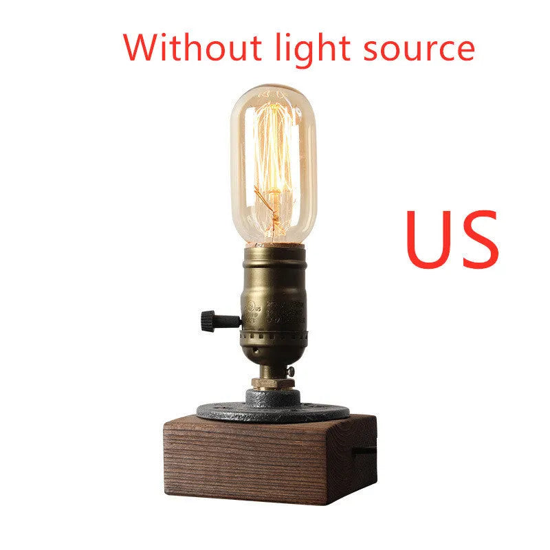 Wood and iron water pipe design table lamp measuring 9 cm wide by 13 cm high.