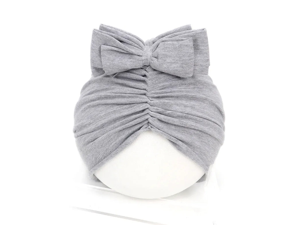 Soft acrylic knitted baby girl turban hat in solid colour fitting 0-28 month infants