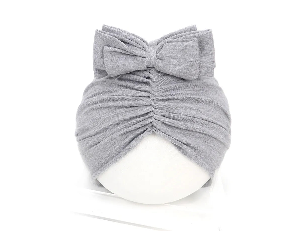 Soft acrylic knitted baby girl turban hat in solid colour fitting 0-28 month infants