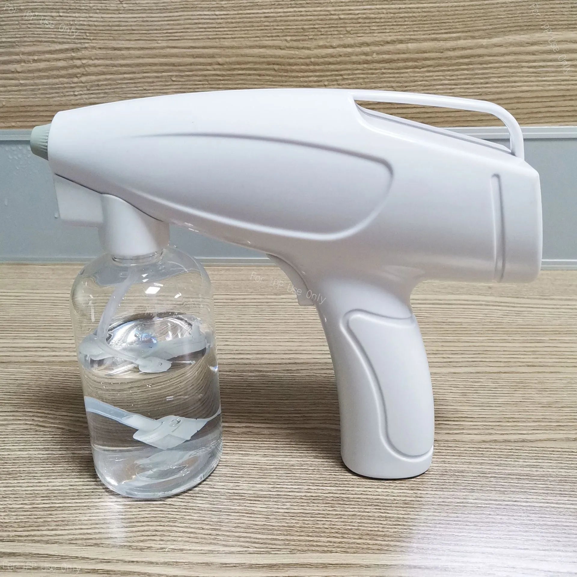 White handheld cordless electric disinfection spray gun with USB-C charging port.