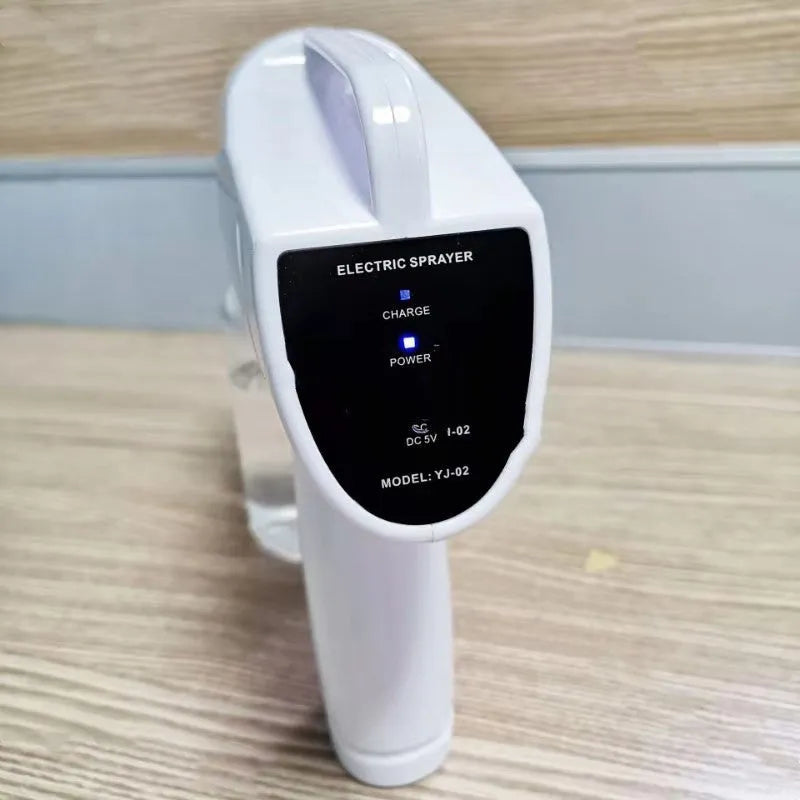 White handheld cordless electric disinfection spray gun with USB-C charging port.