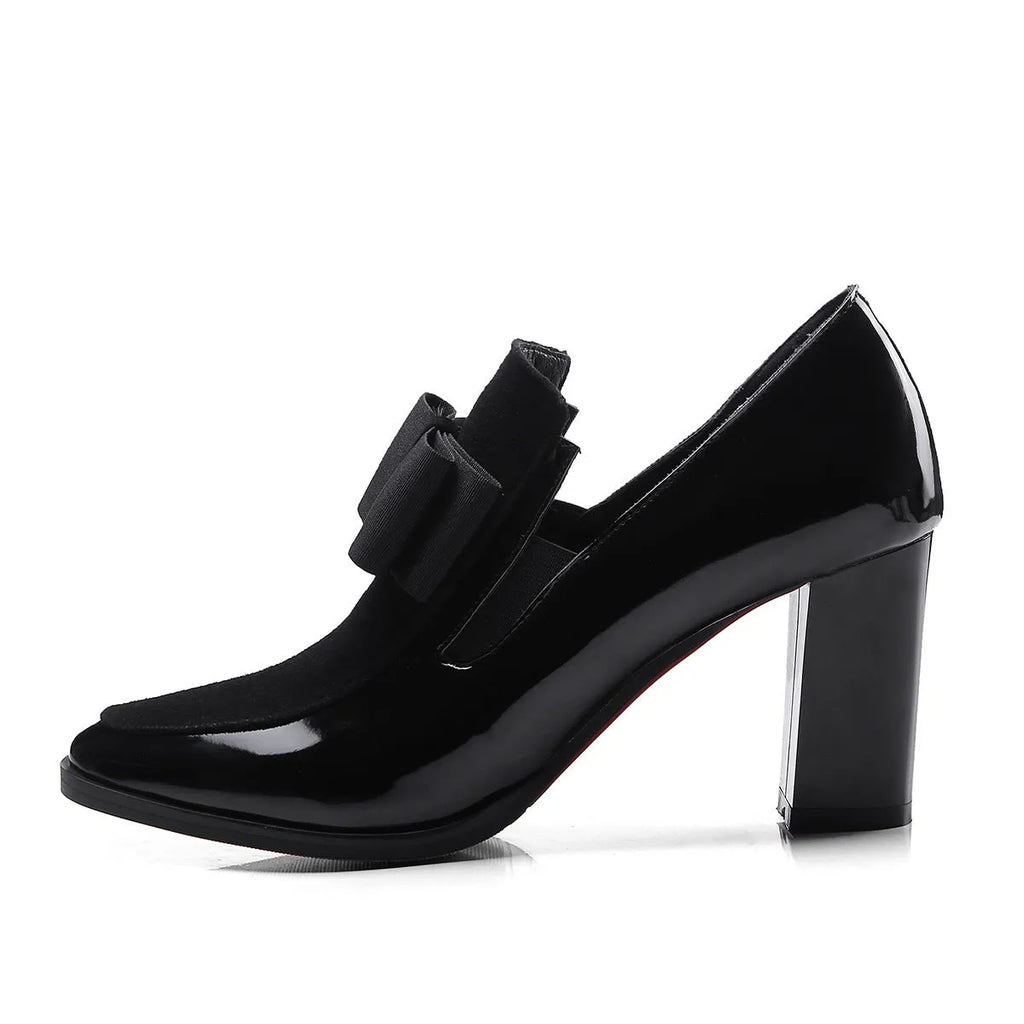 Women's black patent leather high heels with a thick square heel and square toe.