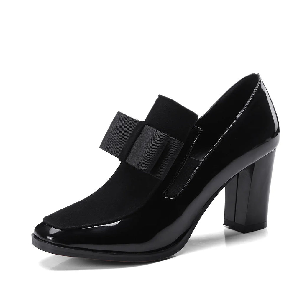 Women's black patent leather high heels with a thick square heel and square toe.