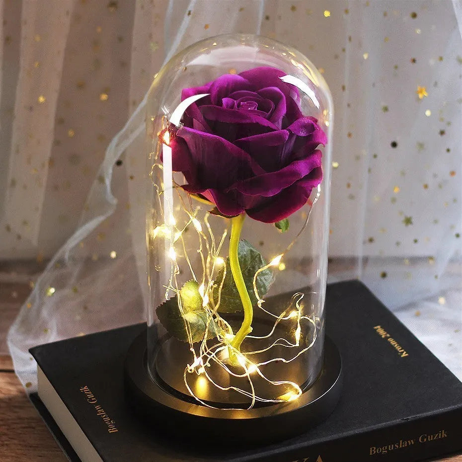Artificial silk rose bouquet with LED string lights and glass lampshade, shown on a wooden base.