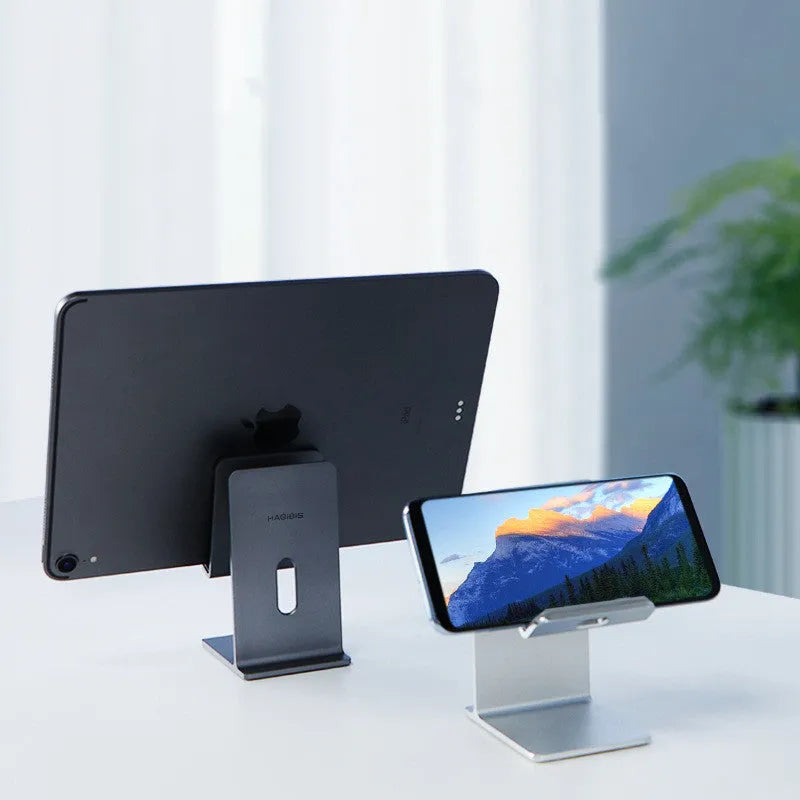 Alloy mobile phone holder on desktop with smartphone inserted, Dark Space Gray colour