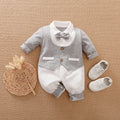 Baby wearing a long-sleeved cotton jumpsuit in a navy blue gentleman style