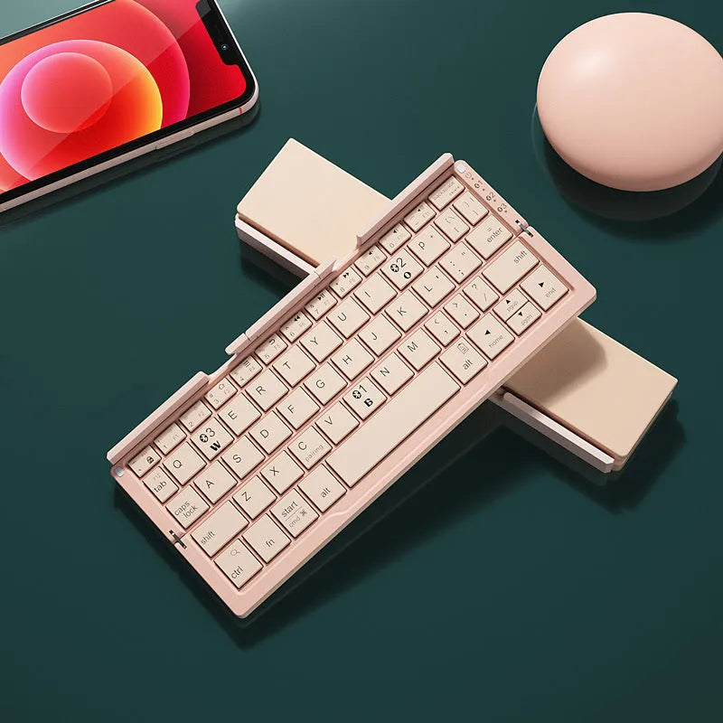 Silver white folding Bluetooth keyboard opened with stand supporting tablet