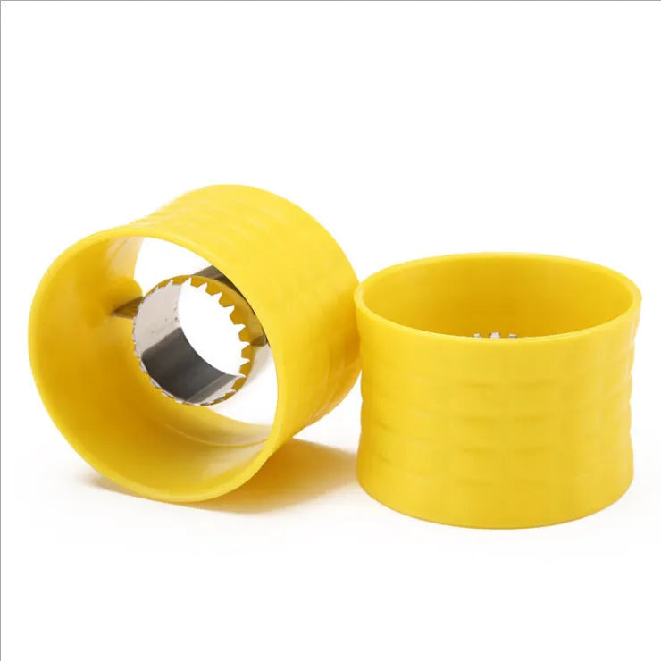 Yellow manual corn grinder thresher with corn-shaped PP handle on a kitchen counter.