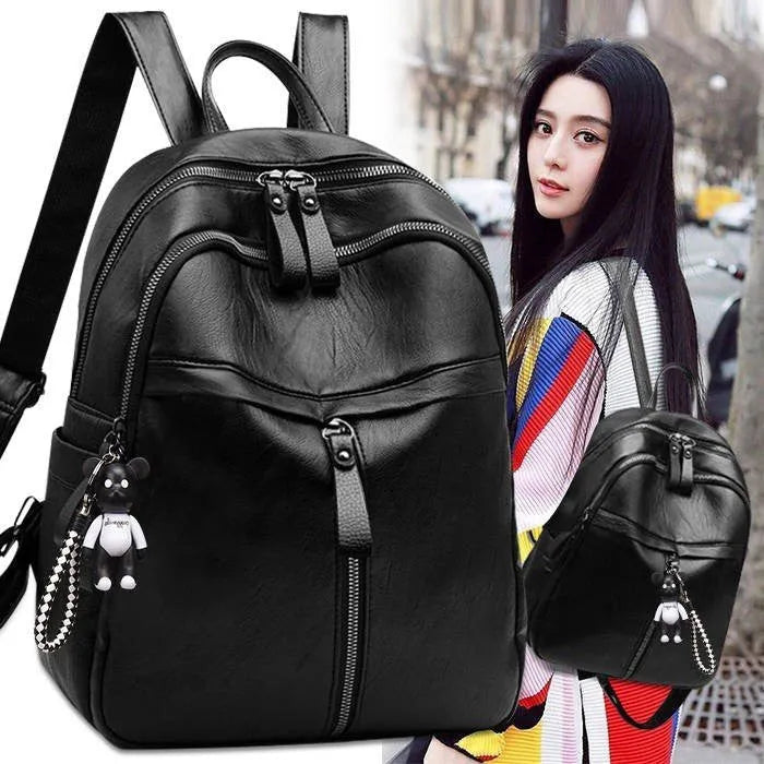 Black PU leather backpack with soft surface showing organised internal compartments and double shoulder straps