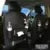 PU leather car seat back storage organiser with multiple pockets hanging behind car headrest