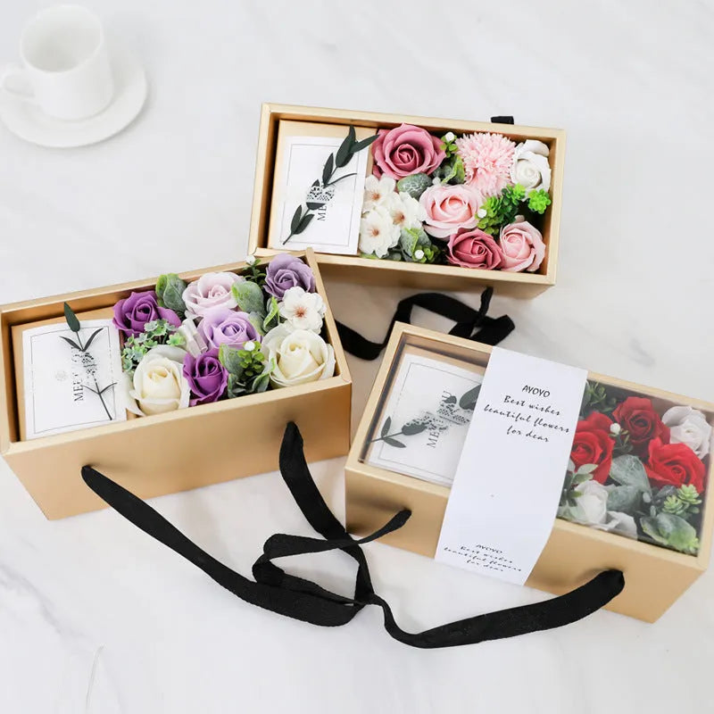 Soap flower rose gift box in golden packaging with greeting card
