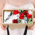 Soap flower rose gift box in golden packaging with greeting card
