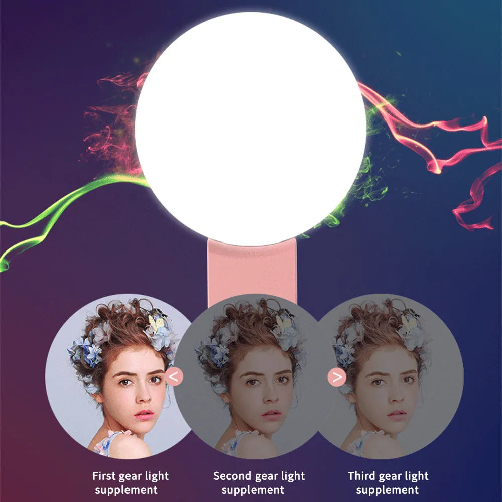 Small round clip-on LED fill light attached to a mobile phone, shown in four colour options.
