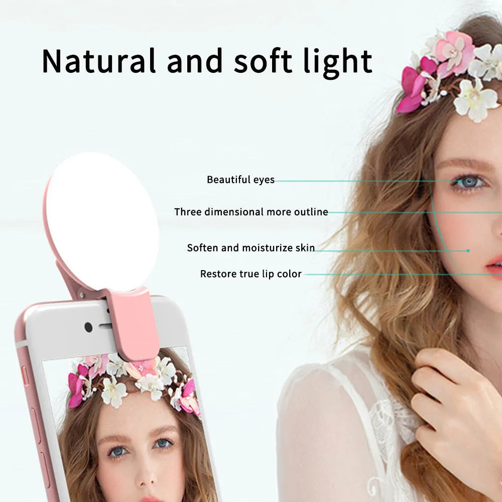 Small round clip-on LED fill light attached to a mobile phone, shown in four colour options.
