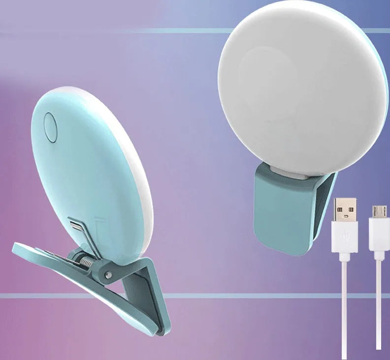 Small round clip-on LED fill light attached to a mobile phone, shown in four colour options.