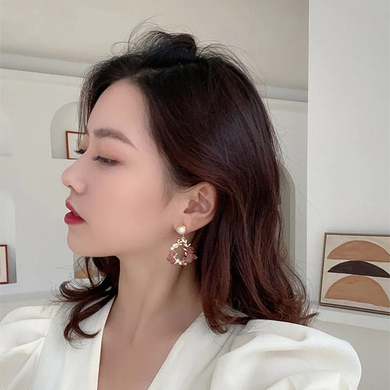 Pink crystal leaf design earrings with silver plated finish on alloy base