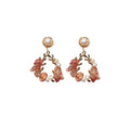 Pink crystal leaf design earrings with silver plated finish on alloy base