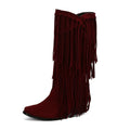 Women's beige suede high heel tassel boots with a square toe and chunky rubber sole