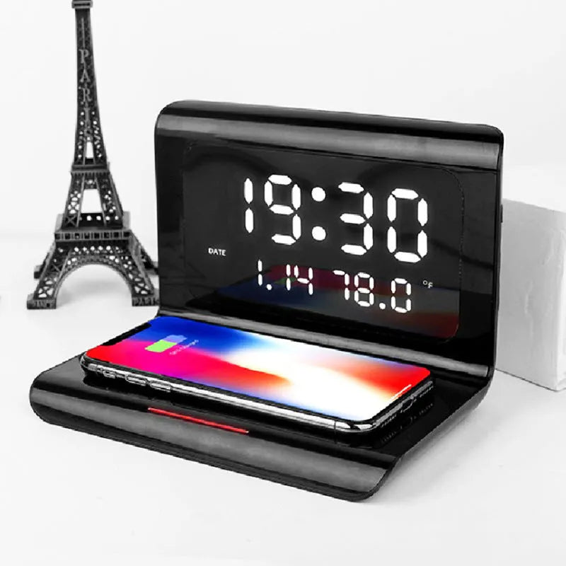 White wireless charger alarm clock displaying time, date, temperature and humidity with phone charging on pad