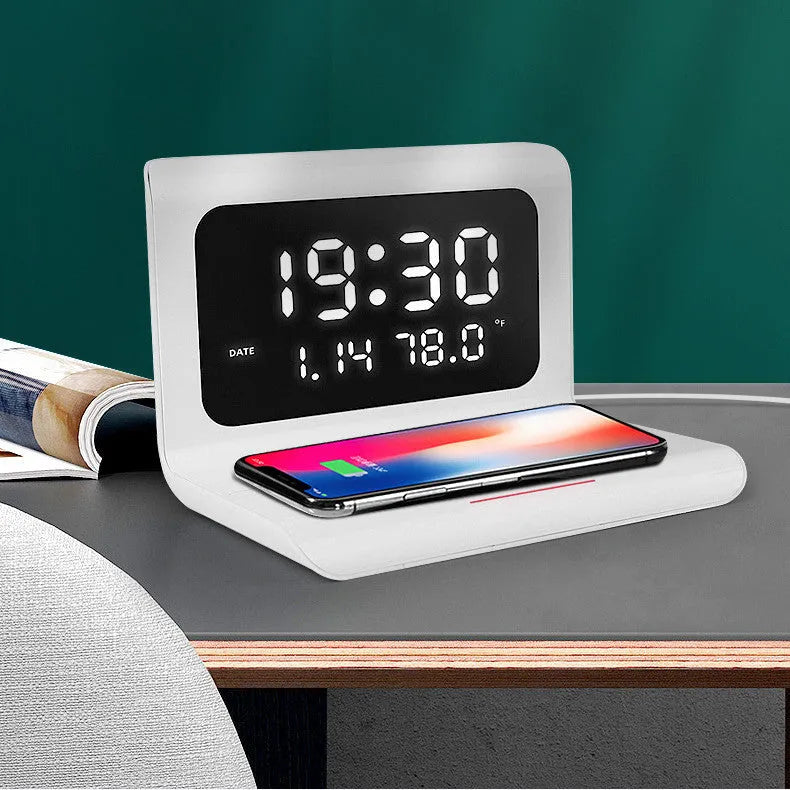 White wireless charger alarm clock displaying time, date, temperature and humidity with phone charging on pad