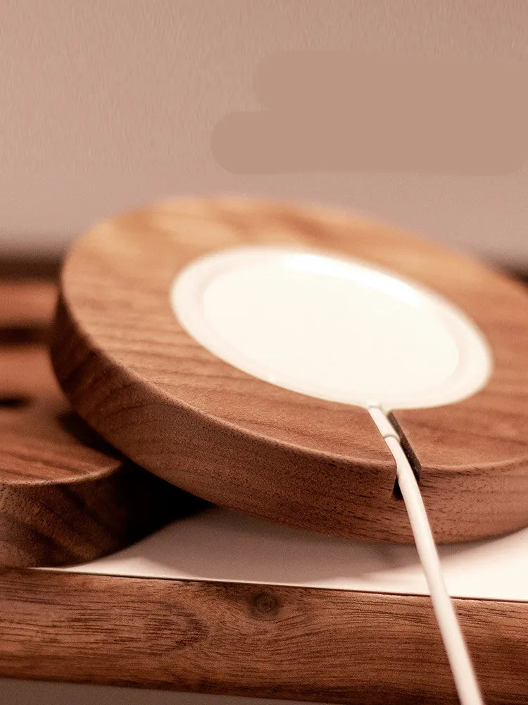 Walnut wood magnetic wireless charging base on desktop with round and square design options