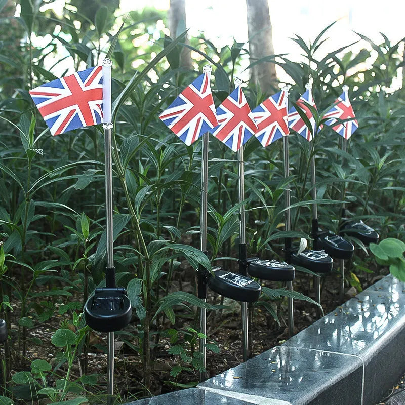 Solar-powered garden flag light showing American flag design on waterproof fabric with stainless steel pole