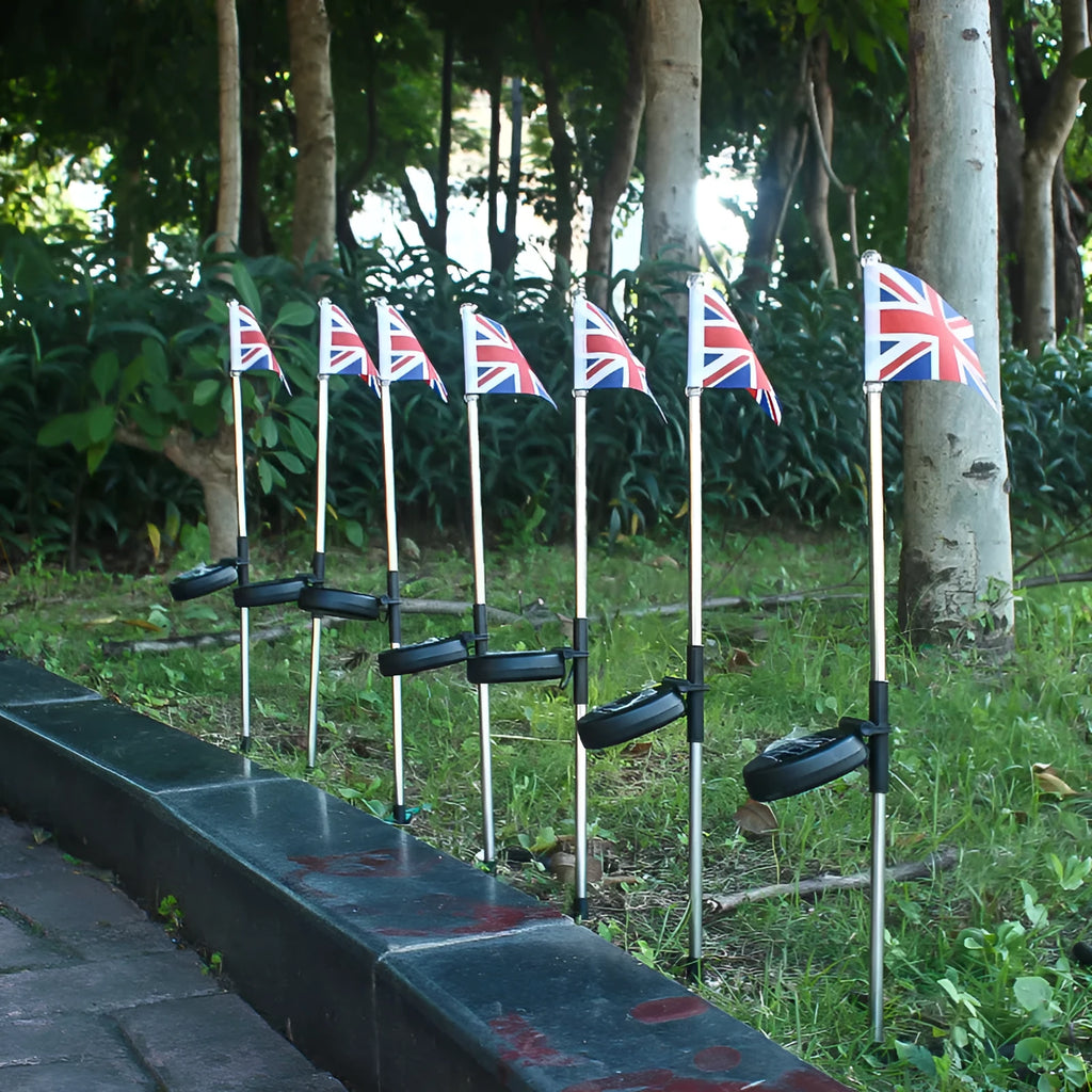 Solar-powered garden flag light showing American flag design on waterproof fabric with stainless steel pole