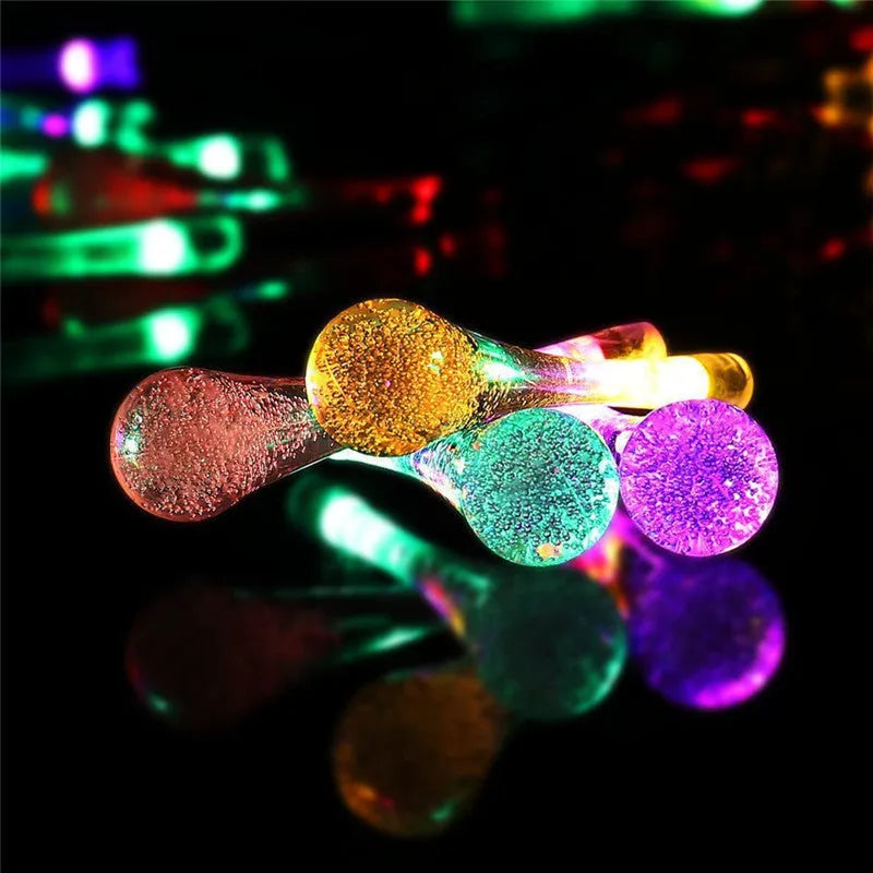 Solar-powered LED outdoor string lights with water drop pendants on a 6.5 metre cable