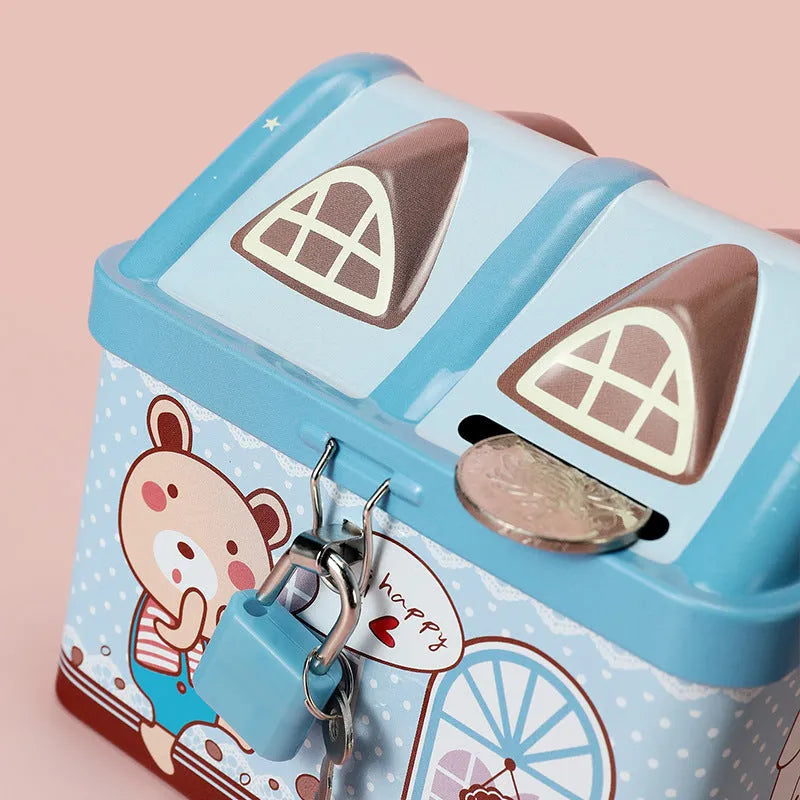Blue house-shaped tinplate piggy bank with removable lid on wooden desk