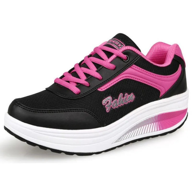 Women's grey and black travel sports shoes with a middle heel, shown from the side.