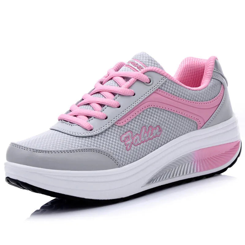 Women's grey and black travel sports shoes with a middle heel, shown from the side.