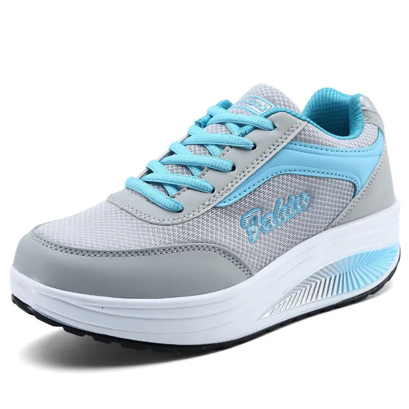 Women's grey and black travel sports shoes with a middle heel, shown from the side.