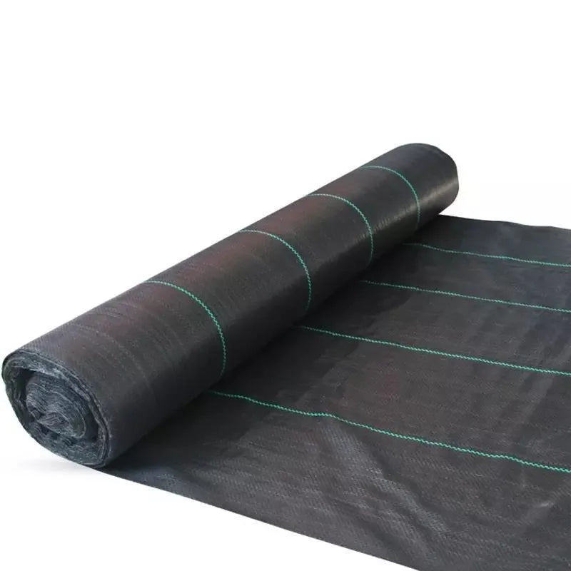 Black plastic weed-proof cloth sheet laid flat on soil for farmland and greenhouse weed suppression.