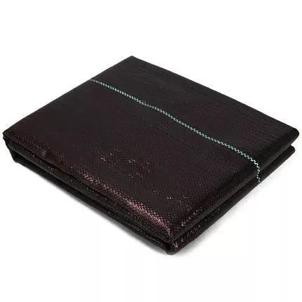 Black plastic weed-proof cloth sheet laid flat on soil for farmland and greenhouse weed suppression.