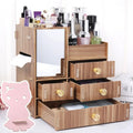 Wooden tabletop cosmetic storage box with a drawer, shown in a selection of its available colours and patterns.