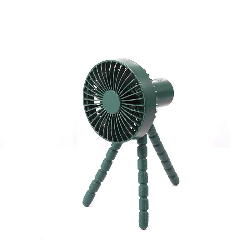 Black USB rechargeable desk fan with flexible tripod legs and an adjustable bending head on a wooden desk.