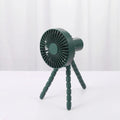 Black USB rechargeable desk fan with flexible tripod legs and an adjustable bending head on a wooden desk.