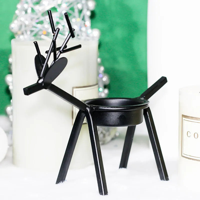 Black iron Christmas deer candlestick holder with elk bracket and festive motifs.