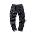 Black men's leather pocket splice cargo trousers with harem cut and long legs