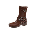 Women's black leather platform boots with a silver belt buckle, shown from the side.