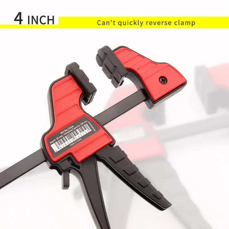 Black plastic woodworking clamp with quick-release lever and rubber grip pads in multiple sizes